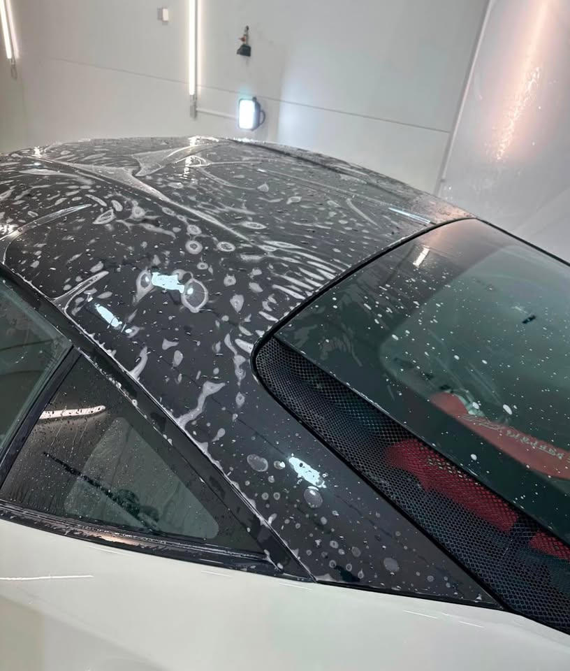 Paint protection film being applied to a sports car roof at Imperial Car Tint